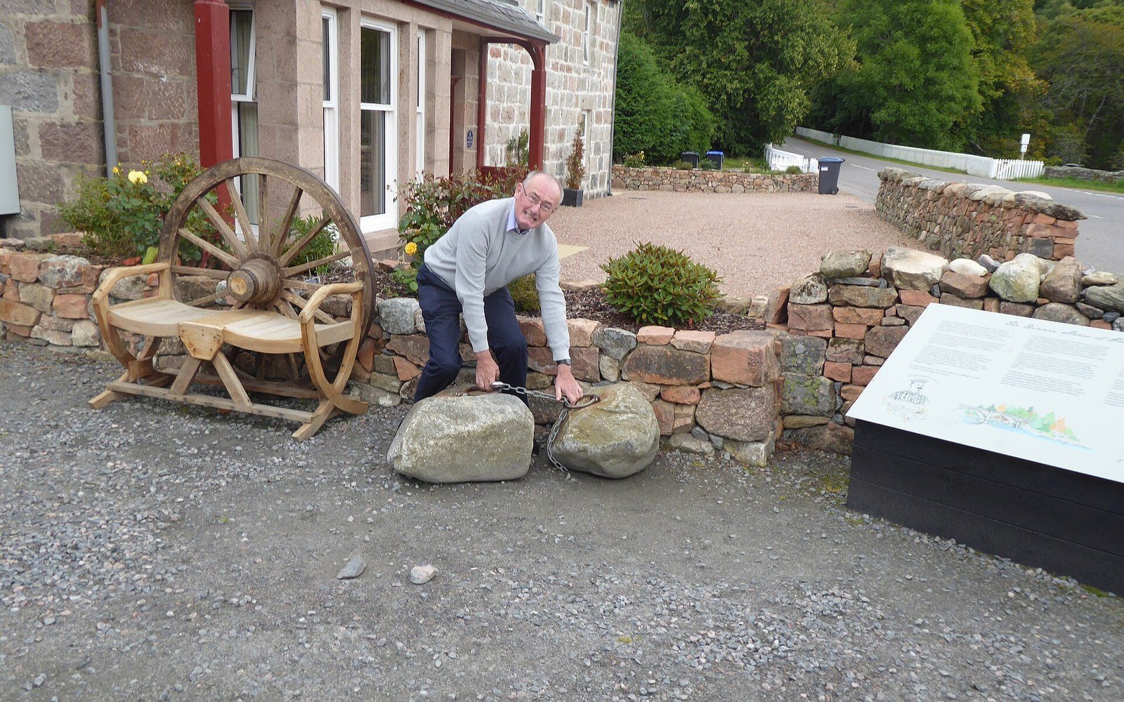 A granite block with an iron ring set in it, lying on grass